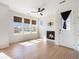 Bright open-concept living room with fireplace, multiple windows, and a ceiling fan at 5755 S Buchanan Ct # E, Aurora, CO 80016