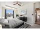 Main bedroom features tray ceiling, ceiling fan, large window, and a walk-in closet at 5755 S Buchanan Ct # E, Aurora, CO 80016