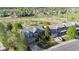 Aerial shot of a neighborhood, featuring well-maintained homes, lush greenery, and a park in the distance at 17925 E Maplewood Dr, Aurora, CO 80016