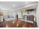 Basement featuring hardwood floors, a stylish bar area, and comfortable seating at 17925 E Maplewood Dr, Aurora, CO 80016