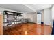 Basement featuring hardwood floors, ample storage shelves, and a functional layout at 17925 E Maplewood Dr, Aurora, CO 80016