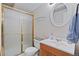 Bathroom featuring a walk-in shower with gold trim and a vanity sink at 17925 E Maplewood Dr, Aurora, CO 80016