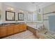 Bright bathroom featuring a shower, soaking tub, double vanity, and natural light at 17925 E Maplewood Dr, Aurora, CO 80016