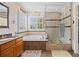 Bathroom featuring a shower, soaking tub, single vanity, and natural light at 17925 E Maplewood Dr, Aurora, CO 80016