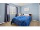 Bedroom featuring a large window, accent wall, and neutral carpet at 17925 E Maplewood Dr, Aurora, CO 80016