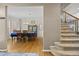 Inviting dining room features hardwood floors, a blue tablecloth, and a view of the staircase at 17925 E Maplewood Dr, Aurora, CO 80016