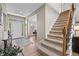 Open entryway featuring hardwood floors, staircase, and a view into the dining room at 17925 E Maplewood Dr, Aurora, CO 80016
