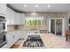 Modern kitchen showcasing white cabinets, granite countertops, stainless steel appliances, and hardwood floors at 17925 E Maplewood Dr, Aurora, CO 80016