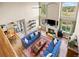 Overhead view of living room with fireplace, tall windows, hardwood floors, and adjacent kitchen at 17925 E Maplewood Dr, Aurora, CO 80016