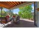 Inviting covered deck with outdoor seating and views of the lush landscape at 17925 E Maplewood Dr, Aurora, CO 80016