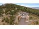 Amazing aerial view of the house nestled high in the mountains at 5197 Bear Mountain Dr, Evergreen, CO 80439