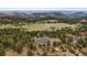 Stunning view of the house and the surrounding area of lush green scenery and other homes at 5197 Bear Mountain Dr, Evergreen, CO 80439