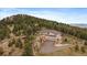 Gorgeous aerial shot of the home situated high in the mountains at 5197 Bear Mountain Dr, Evergreen, CO 80439