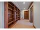 View of basement with built-in bookshelves with wood trim and tile flooring at 5197 Bear Mountain Dr, Evergreen, CO 80439