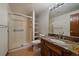 Updated bathroom with stylish vanity, granite countertop, glass shower, and tile flooring at 5197 Bear Mountain Dr, Evergreen, CO 80439
