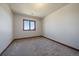 Simple bedroom with neutral carpet and window, offering a cozy and comfortable space at 5197 Bear Mountain Dr, Evergreen, CO 80439
