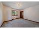 Cozy bedroom with a large window overlooking a green landscape and closet at 5197 Bear Mountain Dr, Evergreen, CO 80439