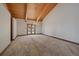 The dining room features vaulted wood ceilings, hardwood floors, a chandelier, and beautiful glass patio doors at 5197 Bear Mountain Dr, Evergreen, CO 80439