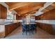 Spacious kitchen with ample cabinetry, stainless appliances, large island, and wood-beam ceilings at 5197 Bear Mountain Dr, Evergreen, CO 80439