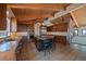 Well-equipped kitchen features wood cabinets, island with seating, stainless appliances, and access to an adjacent living area at 5197 Bear Mountain Dr, Evergreen, CO 80439