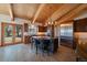 Spacious kitchen with wood beam vaulted ceilings, a large island, stainless appliances, and access to the outdoor living space at 5197 Bear Mountain Dr, Evergreen, CO 80439