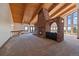 Spacious living room has fireplace, wood ceilings, with many windows and scenic views and lots of natural light at 5197 Bear Mountain Dr, Evergreen, CO 80439