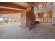 Gorgeous living room featuring vaulted wood ceilings, brick fireplace and big windows with amazing outdoor views at 5197 Bear Mountain Dr, Evergreen, CO 80439