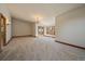 Large living area with wall-to-wall carpet, chandelier, and natural lighting at 5197 Bear Mountain Dr, Evergreen, CO 80439