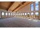 Bright living room features vaulted wood ceilings, oversized windows offering scenic views, and lots of natural light at 5197 Bear Mountain Dr, Evergreen, CO 80439