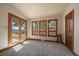 Large living room with wood trim and large windows showcasing the beautiful landscape at 5197 Bear Mountain Dr, Evergreen, CO 80439