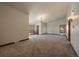 Bright and expansive living area with neutral carpet, natural light, and wood trim at 5197 Bear Mountain Dr, Evergreen, CO 80439