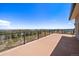 Expansive patio showcasing breathtaking views of the surrounding mountains and clear blue sky at 5197 Bear Mountain Dr, Evergreen, CO 80439