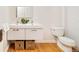 Modern bathroom with double vanity, white countertops, stylish baskets, and a toilet at 2228 N Race St, Denver, CO 80205