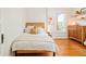 Bright bedroom boasts hardwood floors, a bed, and natural light from a large window with white trim at 2228 N Race St, Denver, CO 80205