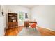 Home office features hardwood floors, large window, wood desk, chair, and a bookshelf at 2228 N Race St, Denver, CO 80205