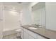 Bright bathroom featuring a tub, white subway tile, gray tile floors, and vanity with solid surface countertop at 710 N Deer Park, Watkins, CO 80137