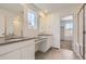 Modern bathroom featuring double vanity sinks, gray countertops, and walk-in shower at 710 N Deer Park, Watkins, CO 80137