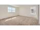 Bright bedroom with neutral carpet, white walls, and plenty of natural light at 710 N Deer Park, Watkins, CO 80137