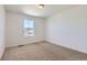Cozy bedroom with neutral carpet, white walls, and natural light from the window at 710 N Deer Park, Watkins, CO 80137