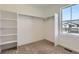 Walk-in closet featuring an installed shelving and plenty of natural light at 710 N Deer Park, Watkins, CO 80137