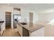 Modern kitchen with gray countertops, stainless steel appliances, and center island at 710 N Deer Park, Watkins, CO 80137