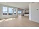 Bright and spacious living room featuring hardwood floors and natural light from large windows at 710 N Deer Park, Watkins, CO 80137