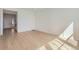 Open-concept living space with hardwood floors, bright white walls, and natural light at 710 N Deer Park, Watkins, CO 80137