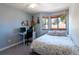 Comfortable bedroom with a large window and desk; decorated with musical instruments at 783 Calgary Way, Golden, CO 80401