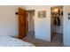Neutral bedroom with plush carpet leading to closet and hallway, featuring an art piece at 783 Calgary Way, Golden, CO 80401
