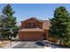 Charming two-story home with attached garage, basketball hoop, and mature trees at 783 Calgary Way, Golden, CO 80401