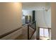 Bright hallway overlooking the lower level, with modern metal railing, and natural light from the windows at 783 Calgary Way, Golden, CO 80401