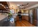 Modern kitchen featuring stainless steel appliances, granite counters, and open shelving at 783 Calgary Way, Golden, CO 80401