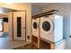 Bright laundry room featuring white washer and dryer and decorative door at 783 Calgary Way, Golden, CO 80401
