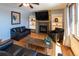 Inviting living room with a fireplace, wood floors, and large windows that bring in plenty of natural light at 783 Calgary Way, Golden, CO 80401